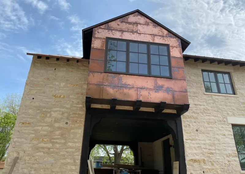 Copper metal panel facade on a stone building for Skylight Installation in Brainerd